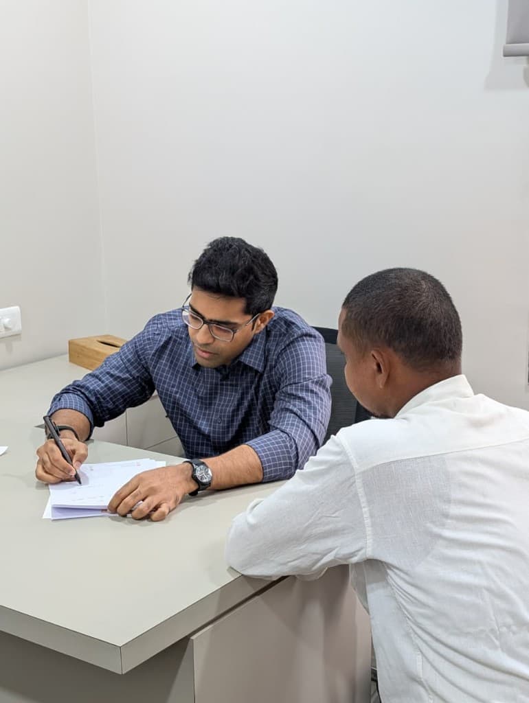 Dr. Neelu Mahendra reviewing reports with a patient at Sri Sitara Hospital, Tanuku